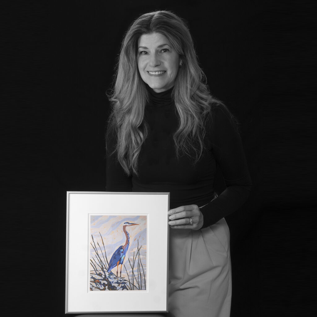 Jill McNair holding artwork