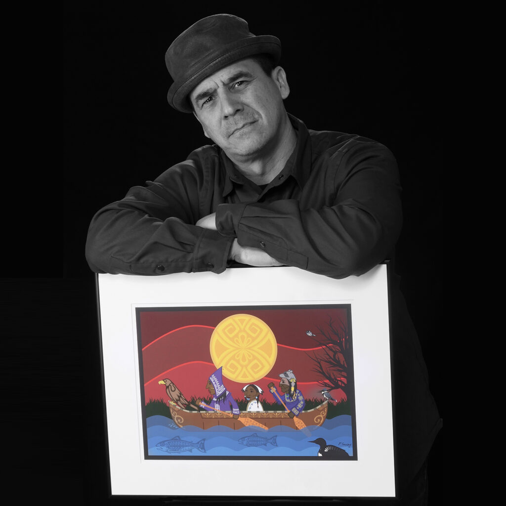 Percy Sacobie holding artwork